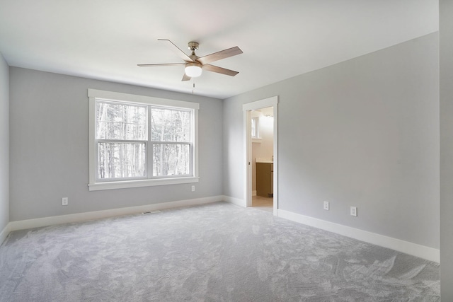 spare room featuring light carpet and ceiling fan