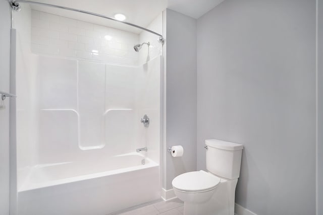 bathroom with tile patterned floors, toilet, and shower / washtub combination