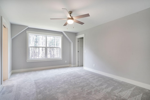 interior space with light colored carpet and ceiling fan