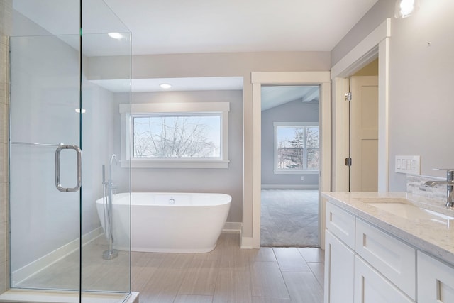 bathroom featuring lofted ceiling, shower with separate bathtub, and vanity