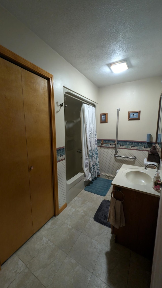 bathroom featuring vanity, a textured ceiling, and a shower with shower curtain