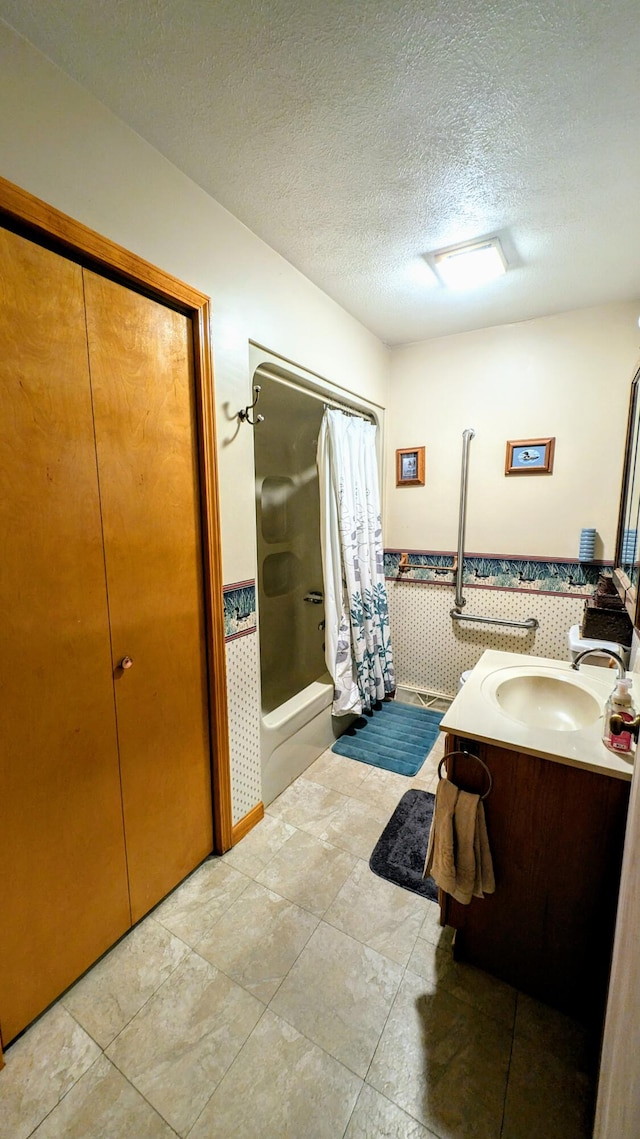 bathroom featuring a textured ceiling, vanity, and a shower with curtain