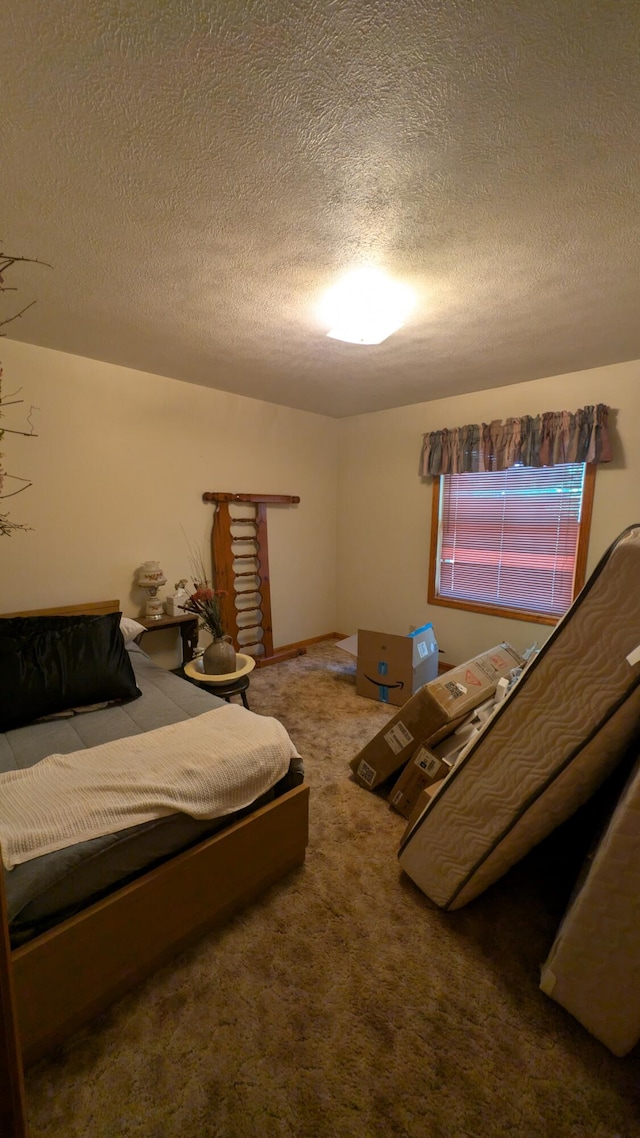 bedroom featuring a textured ceiling and carpet