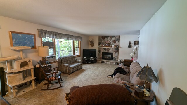 carpeted living room featuring a stone fireplace