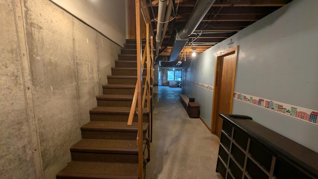 stairs with concrete flooring