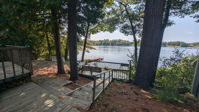 wooden terrace featuring a water view