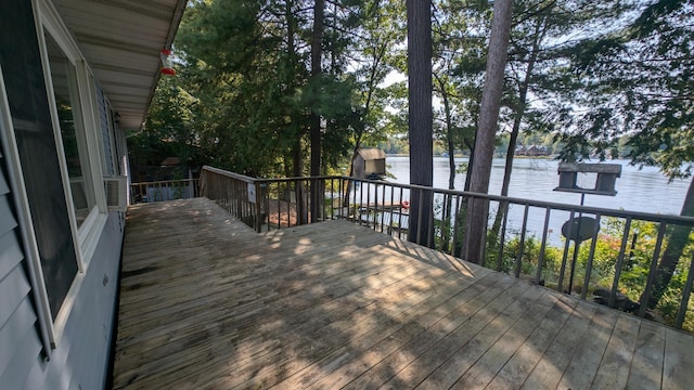 wooden terrace featuring a water view