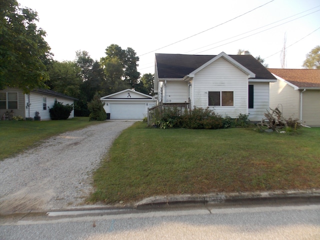 view of front of property featuring a front yard and a garage