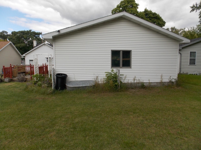 view of side of home with a yard