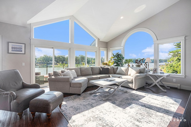living room with high vaulted ceiling, plenty of natural light, baseboard heating, and wood finished floors