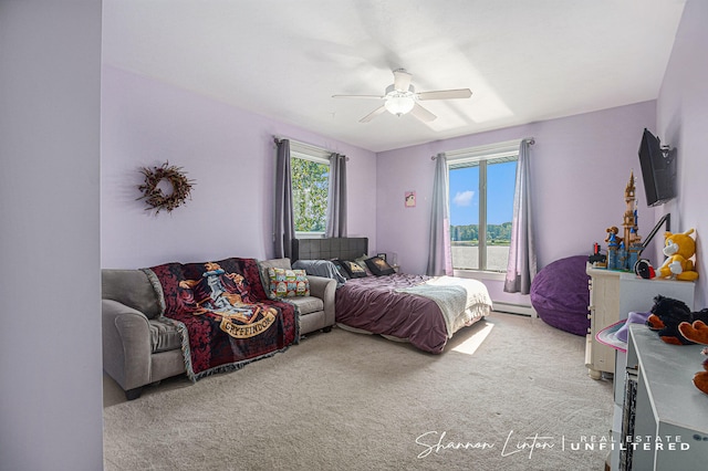 carpeted bedroom featuring a baseboard radiator and ceiling fan