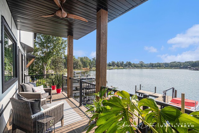 balcony featuring a ceiling fan, a dock, and a water view