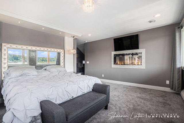 bedroom featuring carpet flooring, recessed lighting, baseboards, and a glass covered fireplace