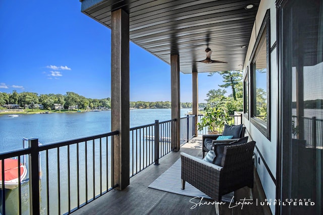 balcony with a sunroom, a water view, and ceiling fan