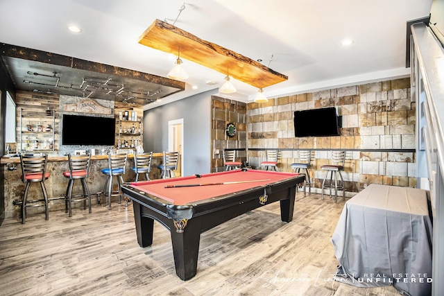 playroom with wood finished floors, recessed lighting, a dry bar, pool table, and an accent wall