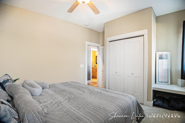 carpeted bedroom with a closet, baseboards, and a ceiling fan