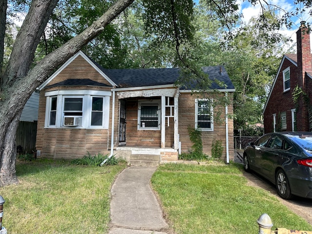 bungalow featuring cooling unit, a front yard, and a porch