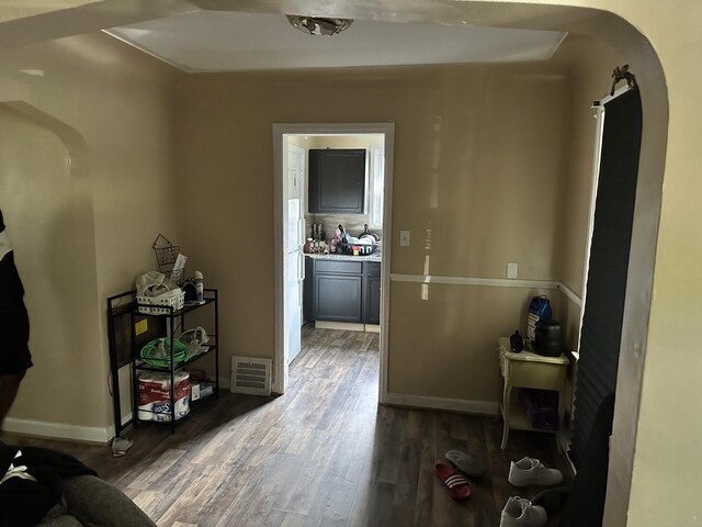 hallway with hardwood / wood-style floors