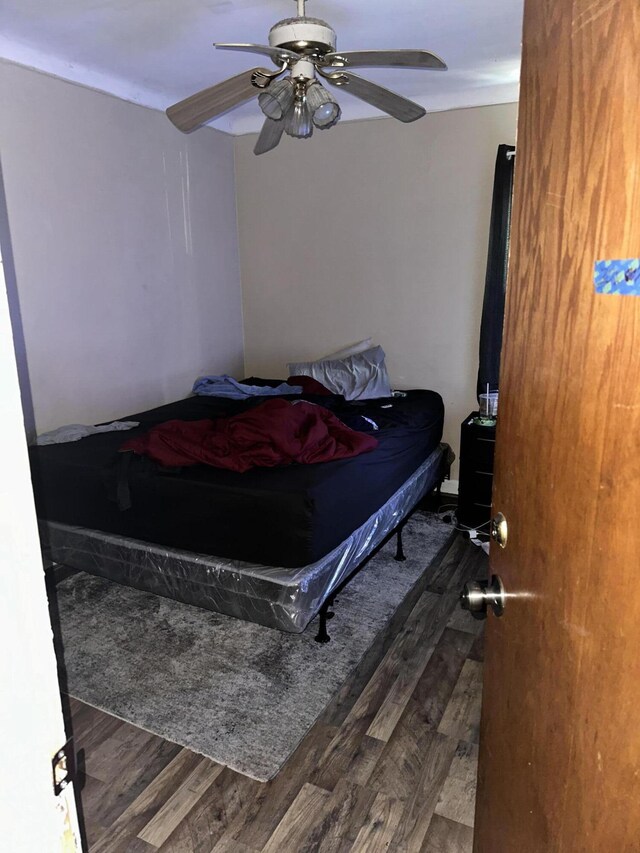 bedroom with ceiling fan and dark hardwood / wood-style floors