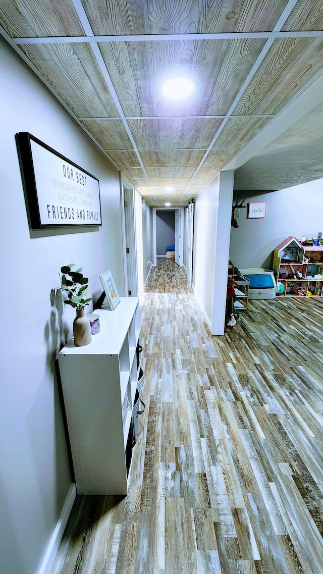 hallway with hardwood / wood-style flooring