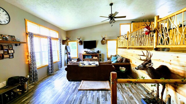 home office with a textured ceiling, lofted ceiling, hardwood / wood-style floors, and ceiling fan