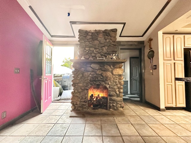 living room featuring a stone fireplace and crown molding