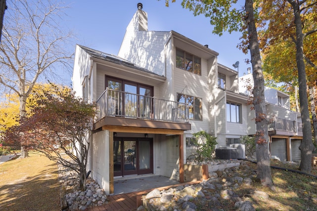 back of property featuring a patio, central AC, and a balcony