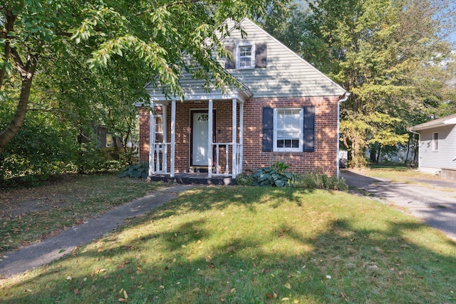 view of front of house with covered porch and a front yard