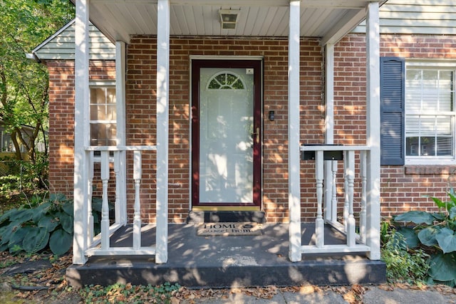 view of exterior entry with covered porch