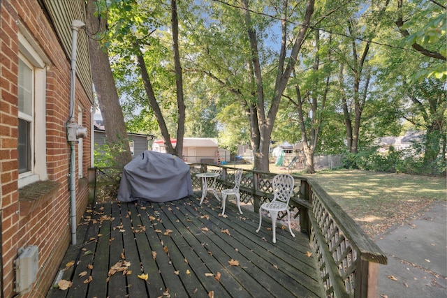 wooden deck with a grill