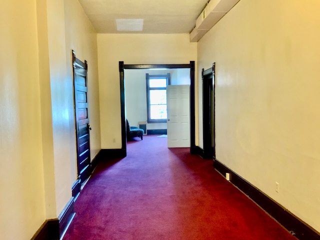 hallway with dark carpet