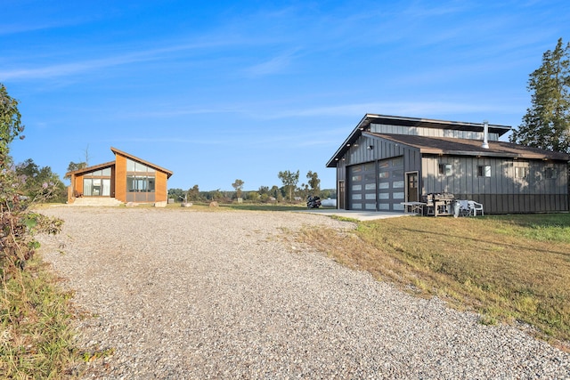 exterior space with a front yard, an outbuilding, and a garage