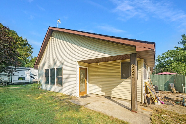 rear view of property with a lawn