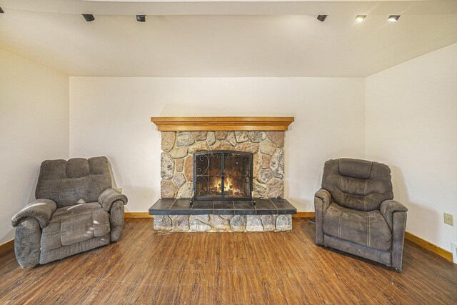 living area featuring hardwood / wood-style flooring and a fireplace