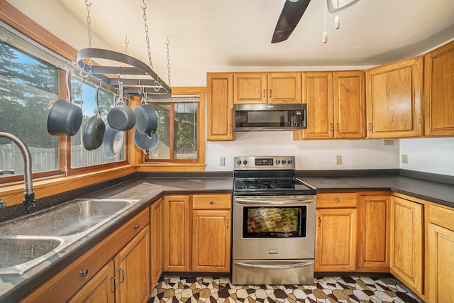 kitchen featuring ceiling fan, sink, and stainless steel electric range