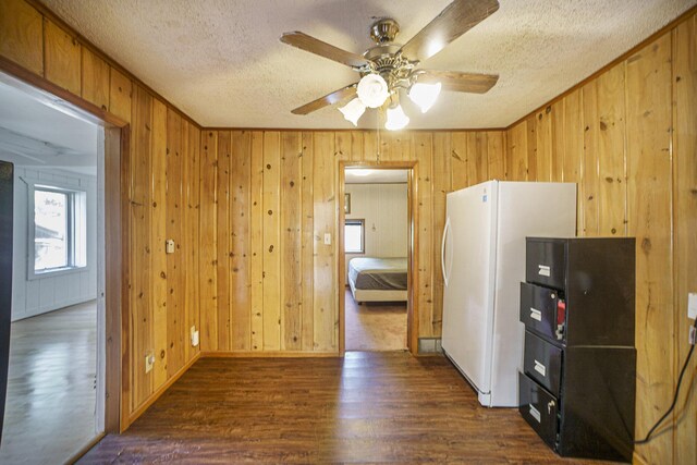 kitchen featuring white refrigerator, ceiling fan, dark wood-type flooring, and a textured ceiling