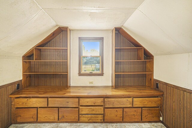 bonus room featuring lofted ceiling and light colored carpet