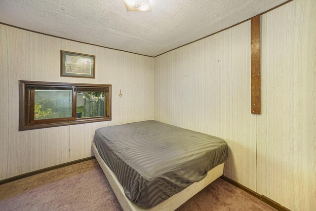 carpeted bedroom featuring a textured ceiling