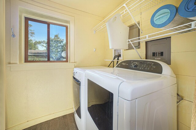 washroom featuring hardwood / wood-style floors, electric panel, and washer and dryer