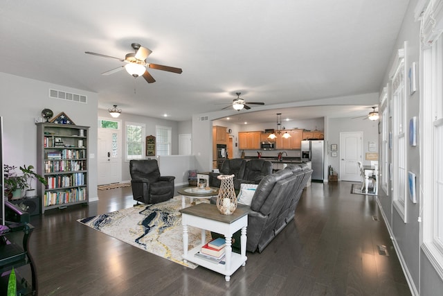 living room featuring dark hardwood / wood-style floors and ceiling fan