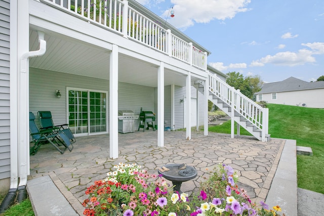 view of patio featuring a deck, area for grilling, and a fire pit