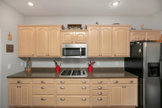 kitchen featuring light brown cabinetry and appliances with stainless steel finishes