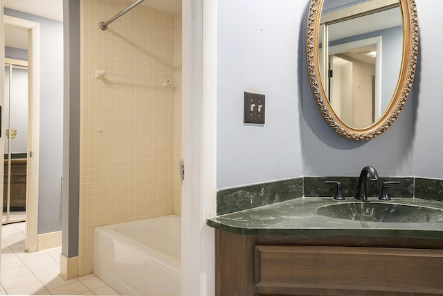 full bathroom featuring vanity, washtub / shower combination, and tile patterned flooring