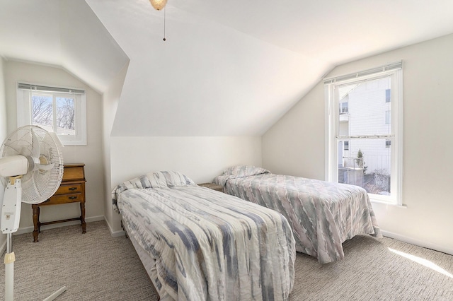 bedroom with vaulted ceiling, carpet flooring, and baseboards