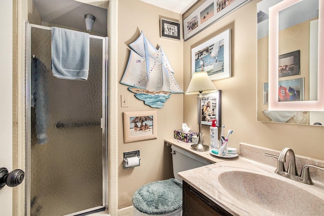 bathroom featuring a shower stall, vanity, and toilet
