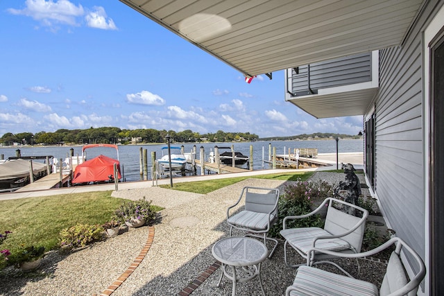 view of patio / terrace featuring boat lift, a water view, and a boat dock