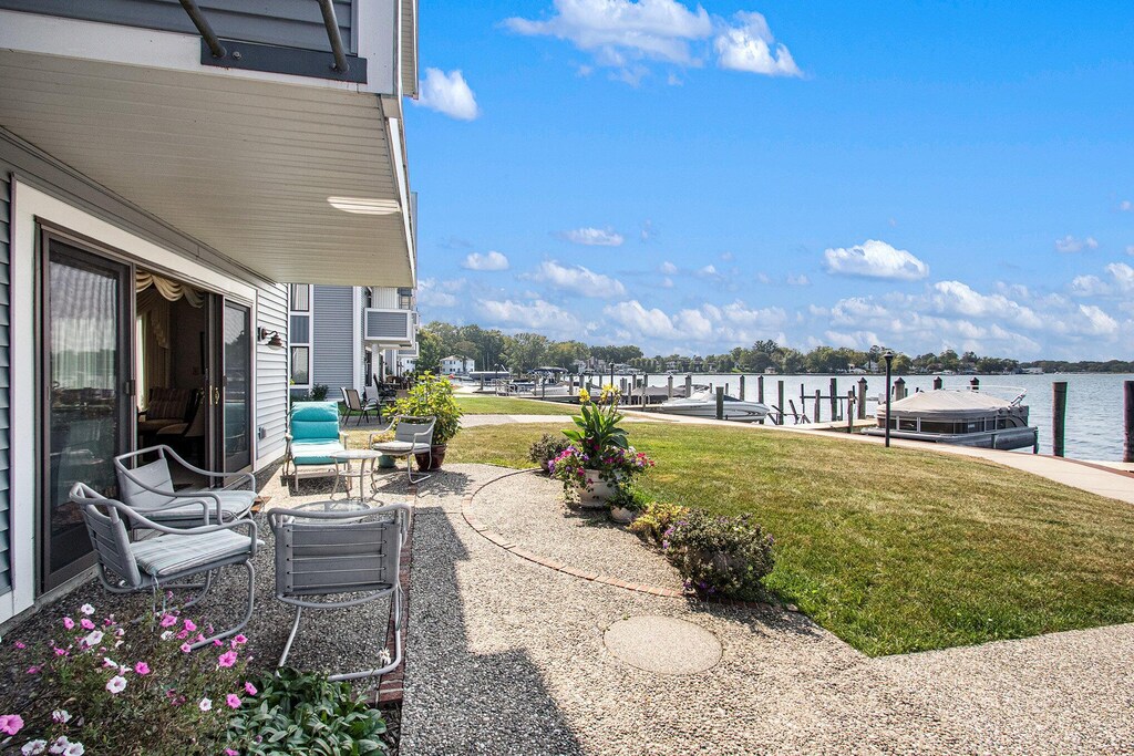 400 Lakeview Ct Unit 1A, Spring Lake, MI 49456 - view of patio featuring a dock and a water view