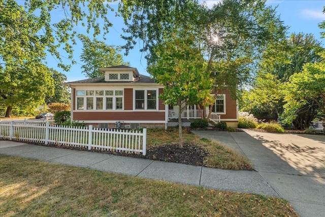 202 Oak St, South Haven, MI 49090 - view of front of home featuring covered porch and a fenced front yard