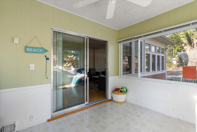 202 Oak St, South Haven, MI 49090 - unfurnished sunroom with visible vents, tile patterned floors, and a ceiling fan