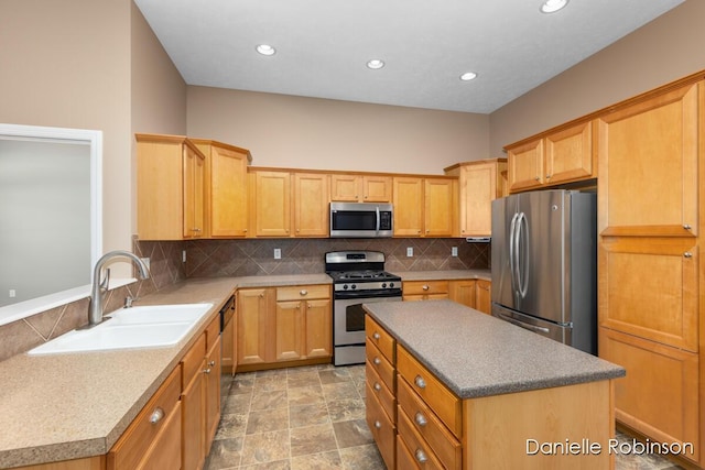 kitchen featuring backsplash, a kitchen island, sink, and stainless steel appliances